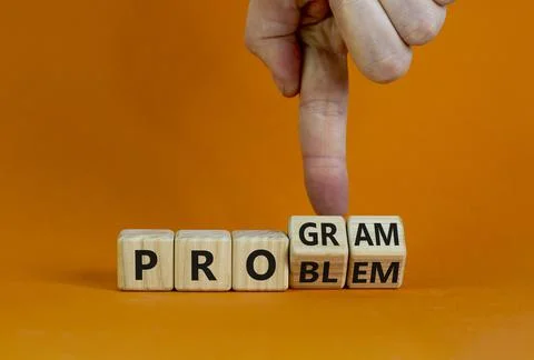 Solving a problem and making program symbol. Businessman turns wooden cubes,  Foto stock