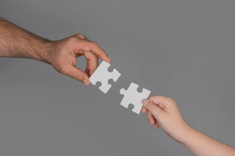 Solving problem needs team communication. Solving puzzle shows logical thinking Stock Photos