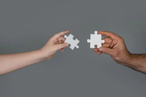 Solving problem needs team communication. Solving puzzle shows logical thinking Stock Photos