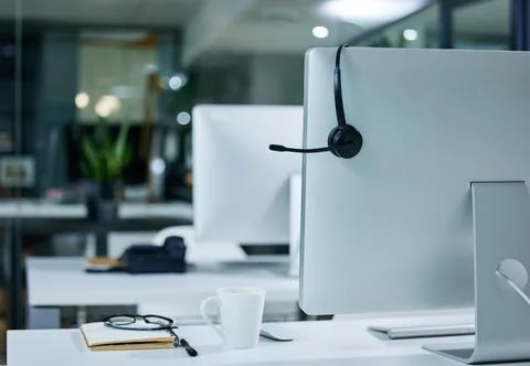 Solving problems one call at a time. Shot of a work station in a call centre. Stock Photos