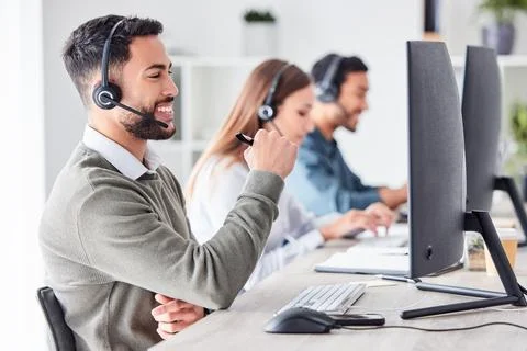 Solving problems one call at a time. a handsome young male call center agent 写真素材
