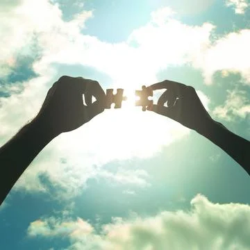 Solving problems piece by piece. Cropped shot of hands holding two puzzle pieces Stockfoto's