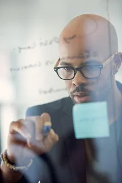 Solving problems is what I do best. a young businessman brainstorming with notes Stock Photos