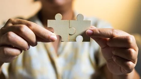 Solving puzzles together collaborative activities indoor space warm lightin.. Stock Photos