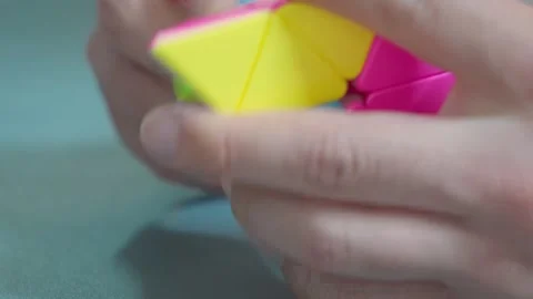 Solving Pyraminx Puzzle Toy Close Up 4K Video stock 339124088