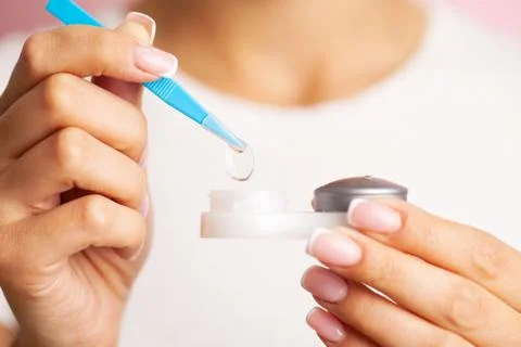 Solving vision problems, close up of woman holding contact lens 스톡 사진