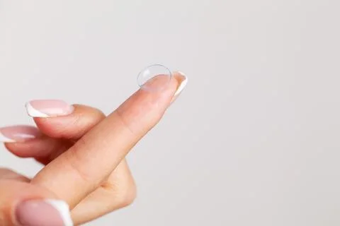 Solving vision problems, close up of woman holding contact lens 스톡 사진
