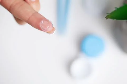 Solving vision problems, close up of woman holding contact lens Stock Photos