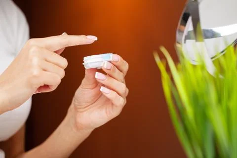 Solving vision problems, close up of woman holding contact lens 写真素材