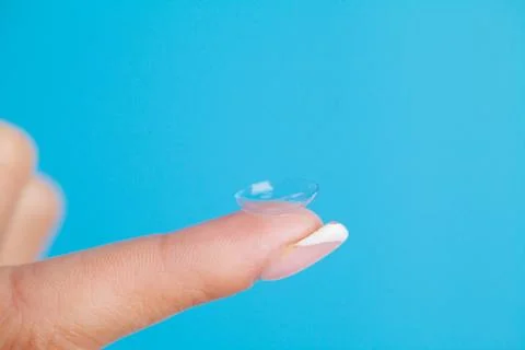 Solving vision problems, close up of woman holding contact lens Stock Photos