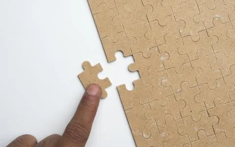 Solving white puzzle on light grey background, top view Stock Photos