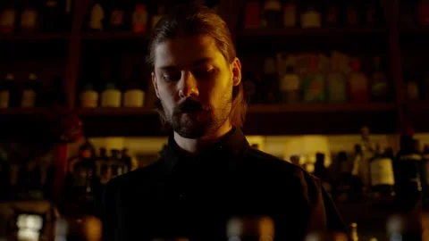 Sombre Bartender in Thought at Dimly Lit Bar Stock Footage 262612182