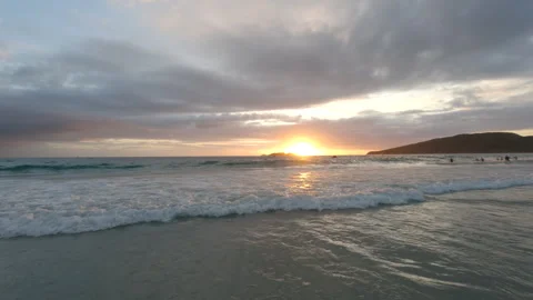 Some athletes training the swimming test in the sea while the sun is rising. Видео 240236461