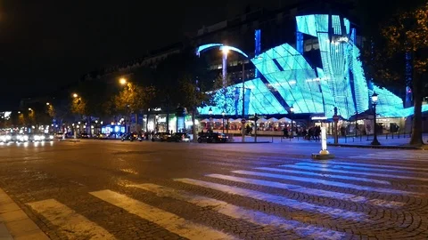 Some avant-garde building of a light blue color on the street of Paris at night Stock Footage 86689431