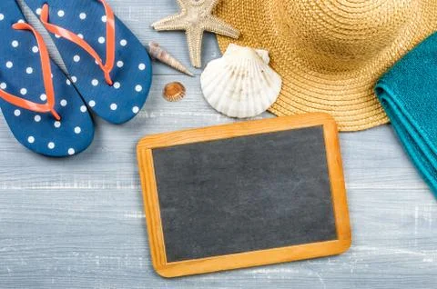 Some beach accessories with an empty chalkboard Photos
