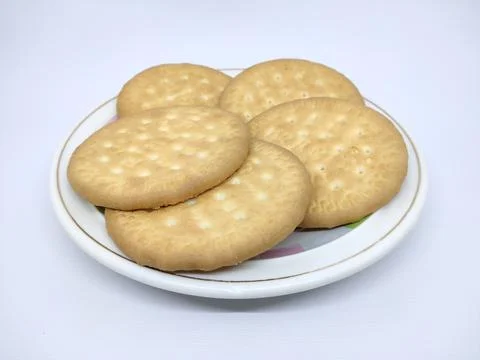 Some biscuits are placed on a plate on a white background Stock Photos