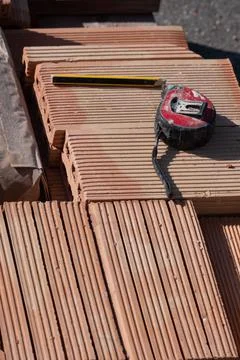 Some bricks and measuring tape on a construction site Stock Photos