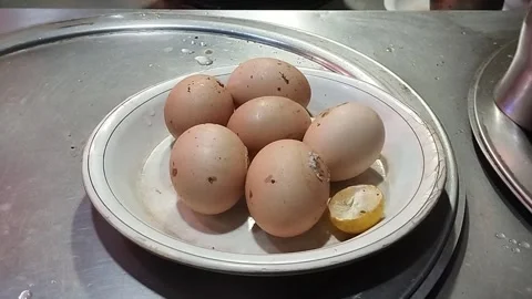 Some Brown Eggs in a Plate with Lemon Piece 動画素材 265486961
