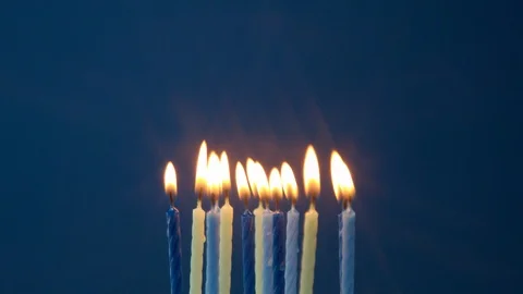 Some candles on blue background blown off Stock Footage 116717594