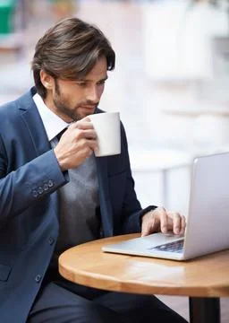 Some casual browsing during my lunch hour. A handsome businessman working on his Stock Photos