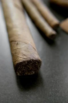 Some cigars over dark background Stock Photos