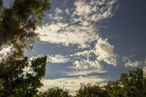 Some clouds behind the trees of a garden in a house of the colonial town of V Stock-Fotos