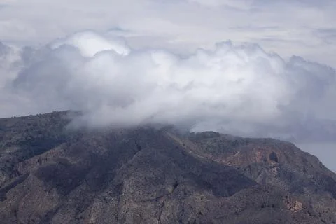 Some clouds on top of a mountain 스톡 사진