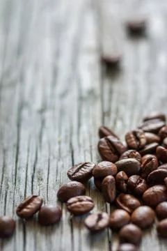 Some coffee beans at old gray wood, vertical frame Stock-Fotos
