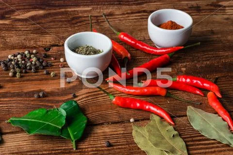 Some condiment lying on wooden surface. Stock Photos