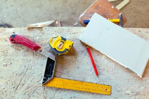 Some construction materials - ruler, construction knife, tape-measure and pencil Stock Photos