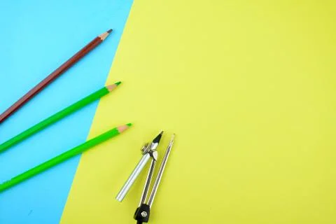 Some different colored pencil crayons and a silver pencil attached to a penci Stock Photos