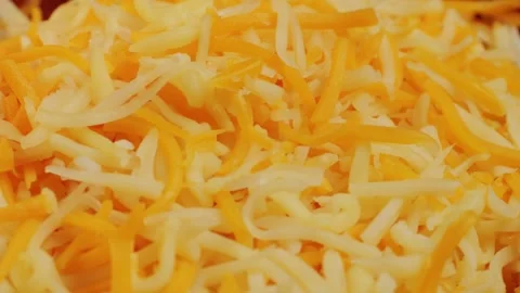 Some different sorts of grate cheese on plate close up macro. Chef grating Stock Footage 259075952
