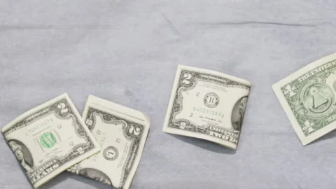 Some dollars bill on the grey background. 動画素材 166582520