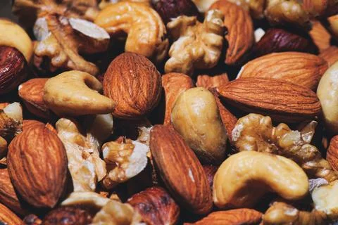 Some dried fruit almonds walnuts cashews and hazelnuts Stock Photos