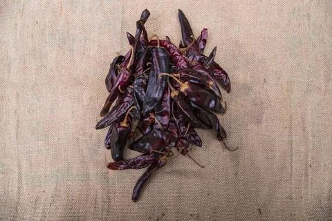 Some Dry Pepper or red chili on the brown jute fiber fabric Stock Photos