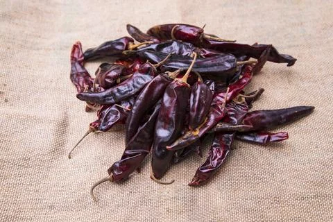 Some Dry Pepper or red chili on the brown jute fiber fabric Stock Photos