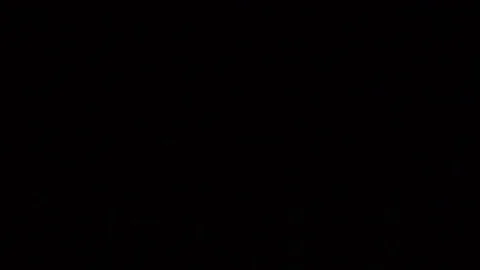 Some dust of liquid particles flowing on dark background Stock Footage 75098855