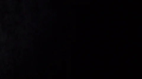 Some dust of liquid particles flowing on dark background Stock Footage 75099330