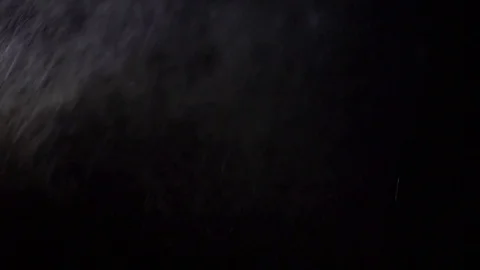 Some dust of liquid particles flowing on dark background Stock Footage 75099589