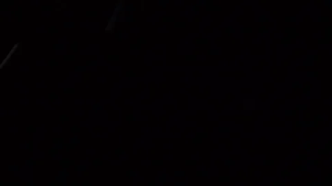 Some dust of liquid particles flowing on dark background Stock Footage 75099736