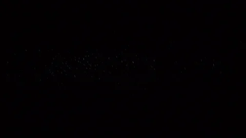 Some dust of liquid particles flowing on dark background Stock Footage 75099964