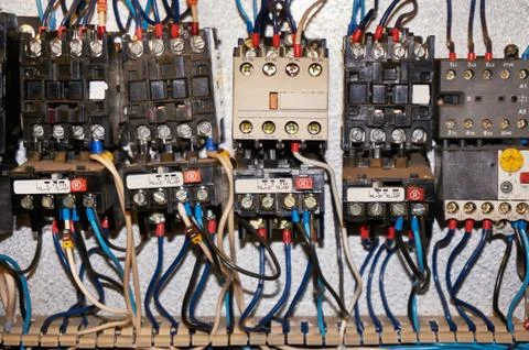 Some electrical relay is mounted on the mounting panel. Stock Photos