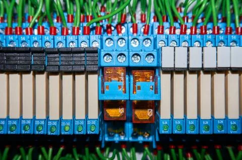 Some electrical relay is mounted on the mounting panel. Stock Photos