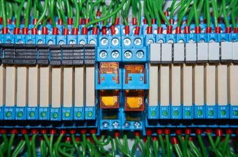 Some electrical relay is mounted on the mounting panel. Stock Photos