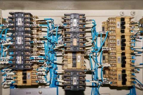 Some electrical relay is mounted on the mounting panel. Stock Photos