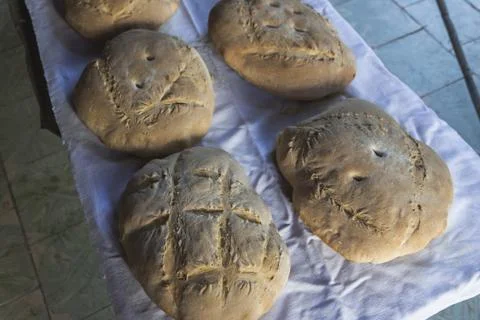 Some fresh baked breads with patterns arranged on the white towel Stock Photos