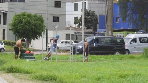 Some friends doing exercises on a bar of a mini gym in the street park Stock Footage 149906047