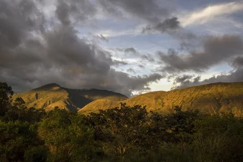 Some gray clouds floating over the Iguaque mountain at sunset, near the colon Stock Photos