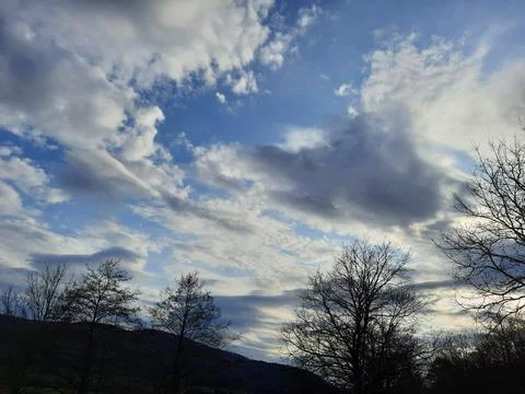 Some gray-white clouds in the sky. The streaks of clouds are diffuse and reflect Stock Photos