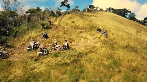 Some guys on dirt bikes having hard time on a mountain Stock Footage 90654836